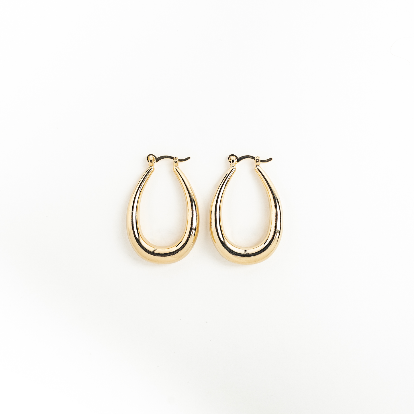 Gold hoop earrings on a white background